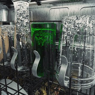 Four differently sized cups and bottles being cleaned by the bottle wash jets.