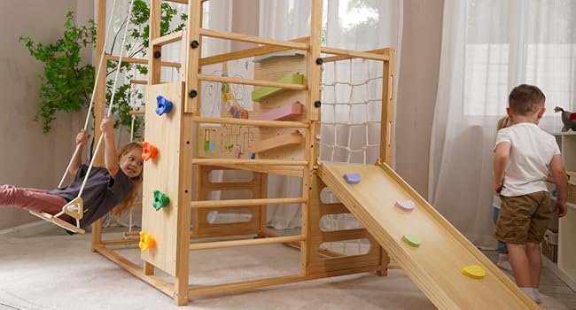 child laughing and swinging on montessori climbing gym